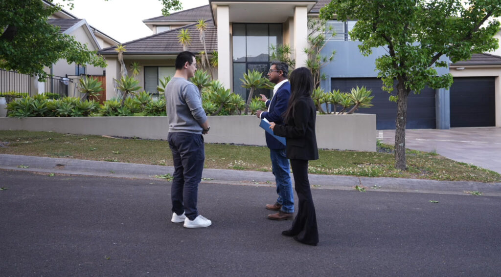 Real estate consultation in front of residential property